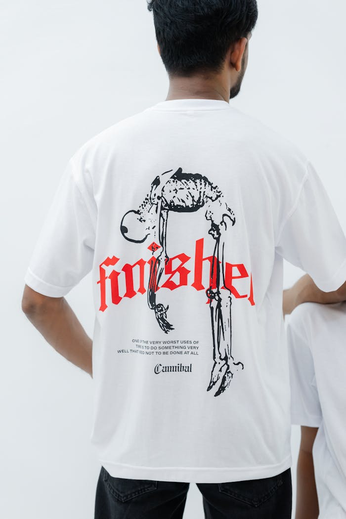 person-wearing-t-shirt-with-skeleton-design-and-finished-text-32587144